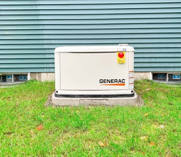 A residential standby generator beside a home
